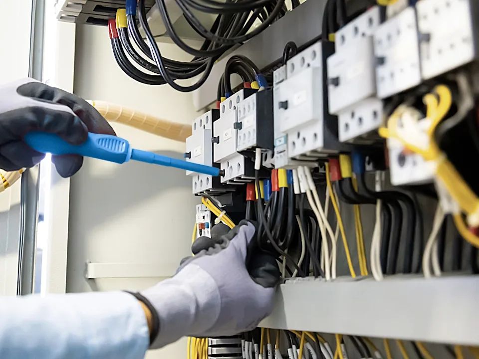 Engineer inspecting electrical box ensuring everything is up and running.