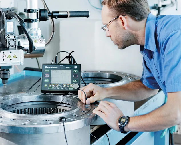 Un ingénieur utilise une sonde pour la mesure de précharge ultrasonique dans une application industrielle.
