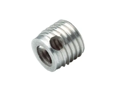 Short silver FASTEKS metal threaded insert with side cutting hole on a white background.