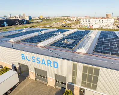Aerial view of the Bossard business unit in the Netherlands, showcasing the building with solar panels and the surrounding outdoor areas.