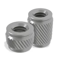 Two PEM CastSert press-in threaded inserts on white background