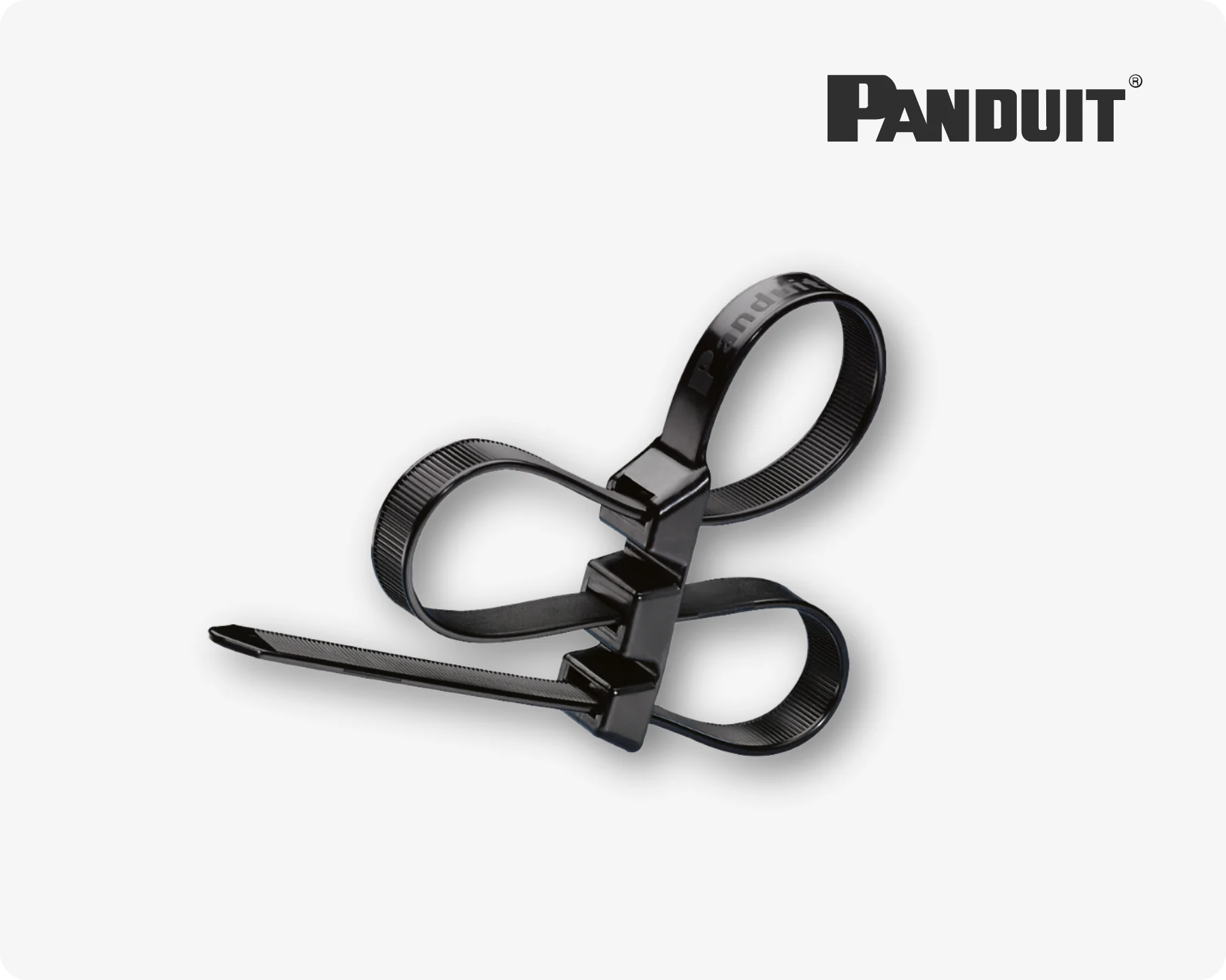 Close-up of a black Panduit cable tie with three entry points on a light grey background.