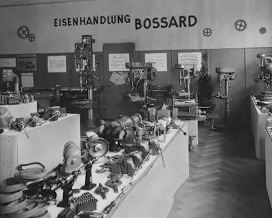 A vintage black and white photo of a 1930s Bossard ironmongery shop filled with various tools and equipment.