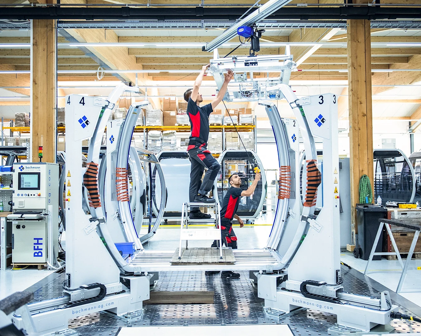 Technicians working on a CWA cabin in a modern manufacturing facility