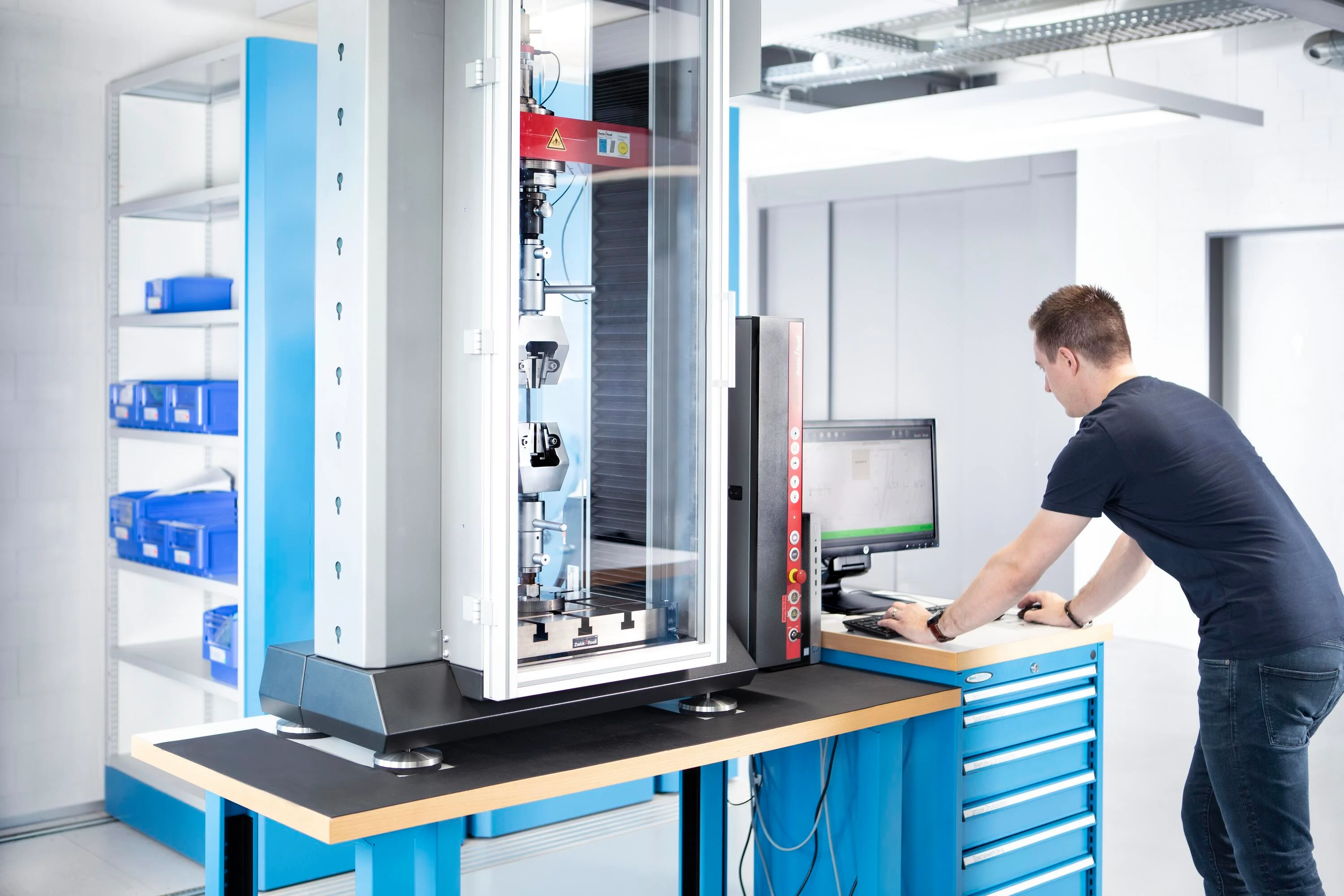 Engineer is conducting a tensile strength test in a technical test lab.