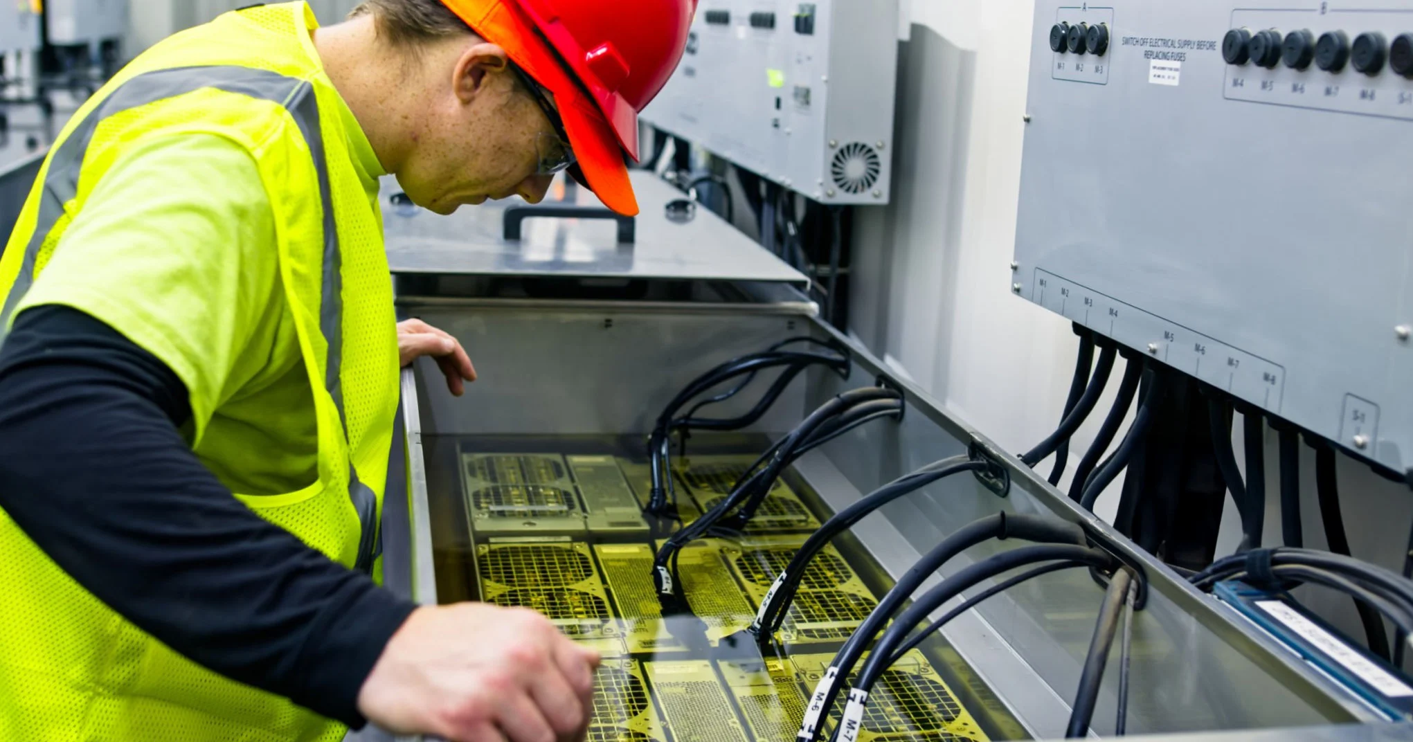 A man looking over a high performance data center liquid cooling setup