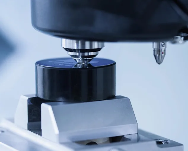 Close-up of hardness testing machine.