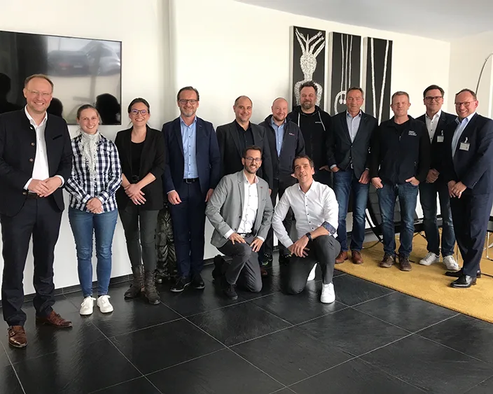 Gruppe von Fachleuten von Bossard und WEH posiert gemeinsam in einem geschäftlichen Umfeld