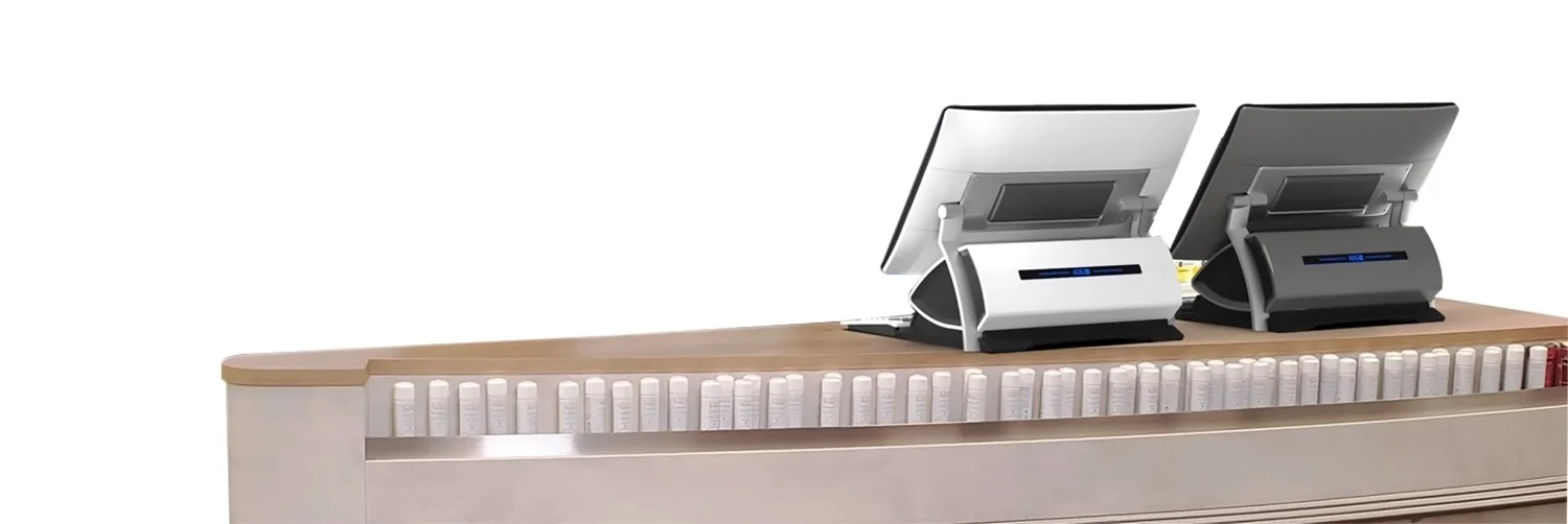 Two JDM point-of-sale systems for the pharmacy market on a sales counter, viewed from the backside.