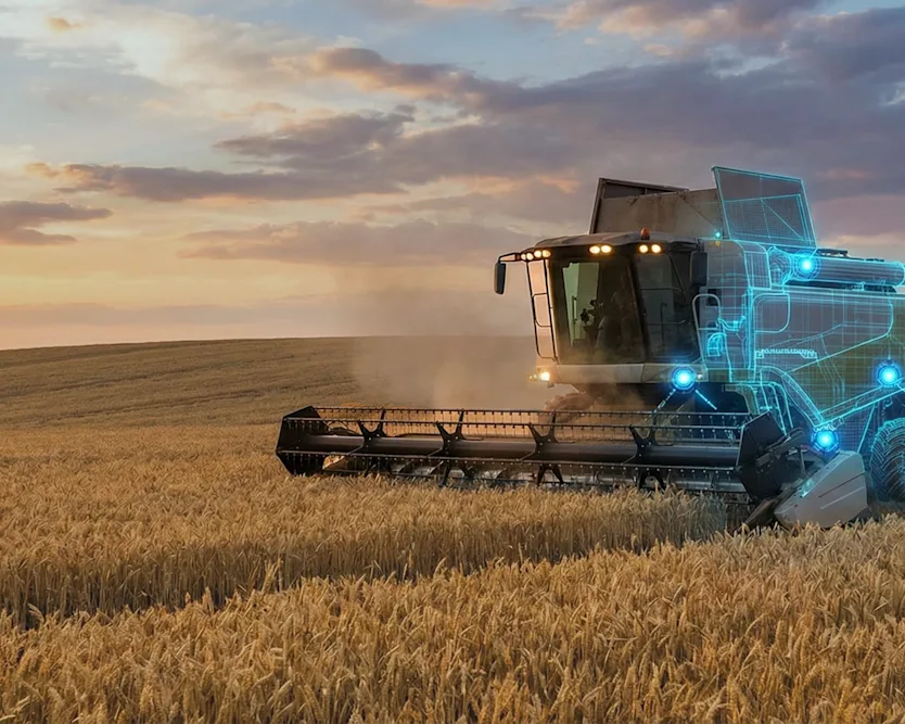 Combine in field at dusk with blueprint lights to highlight equipment components