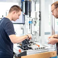 Two engineers are working on a test setup for a torque analysis, directly at test bench