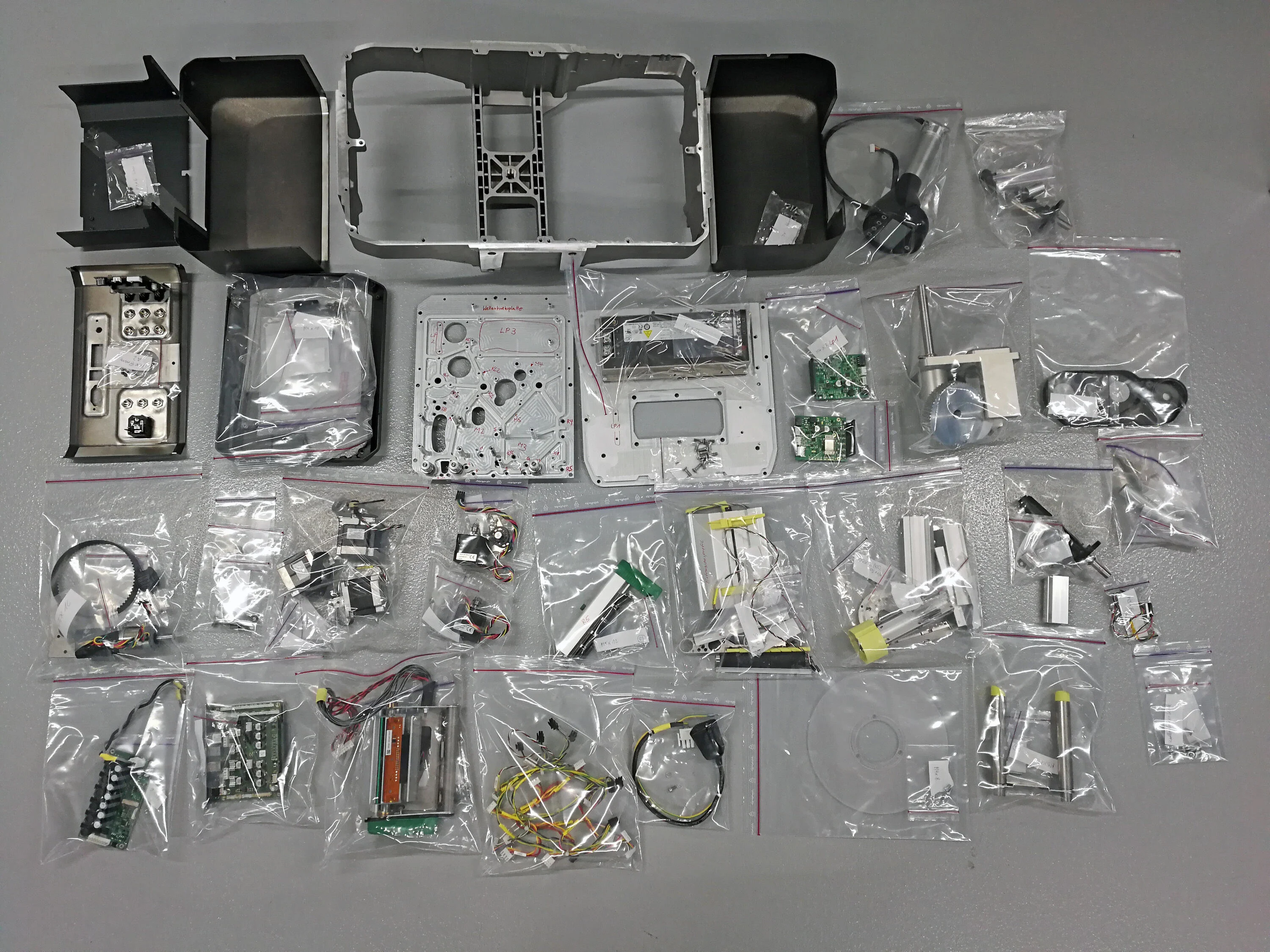 A meticulous exploded assembly of all label printer components after a teardown.