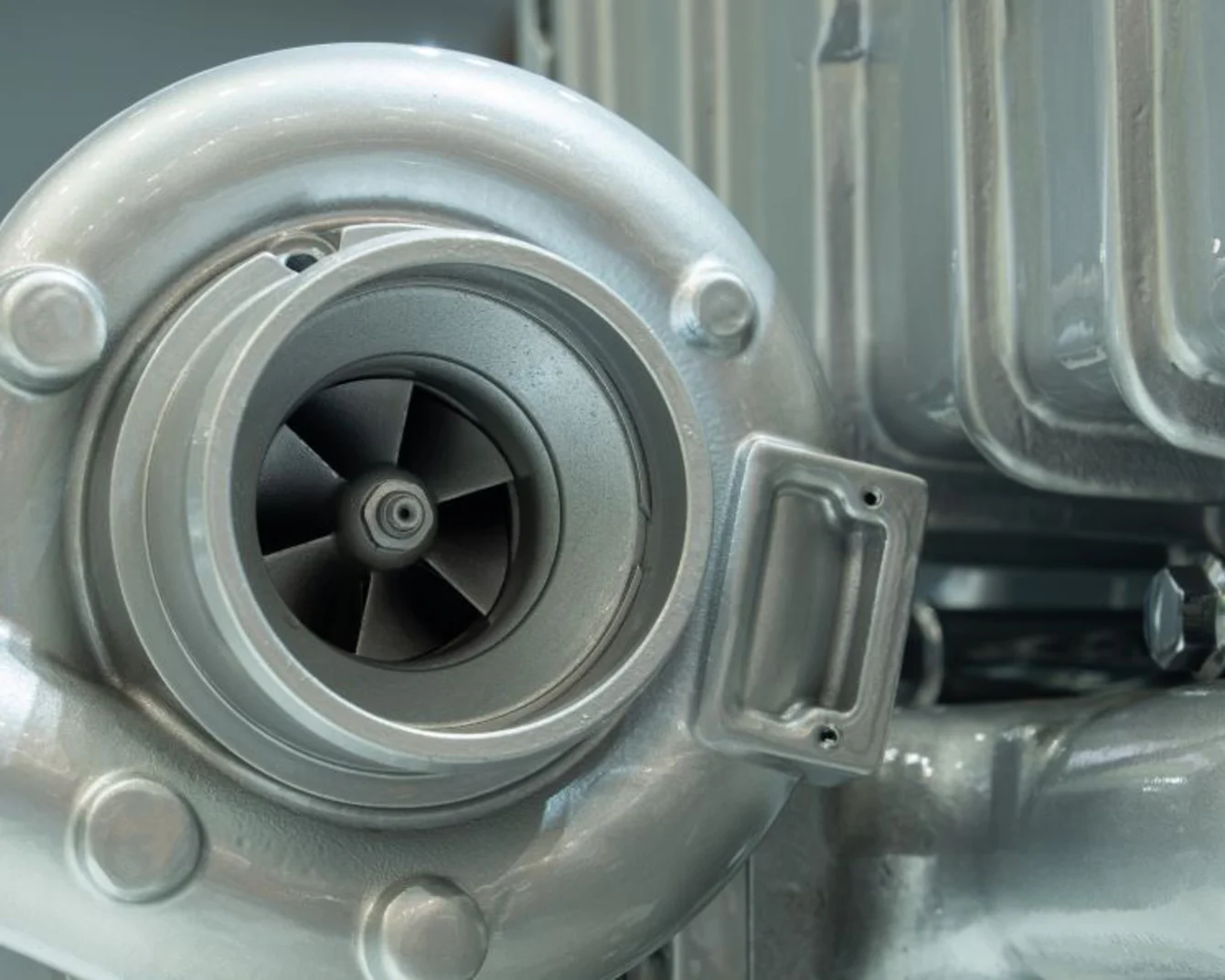 Close-up view of a turbo engine featuring a prominent turbocharger, showcasing intricate details and engineering design.
