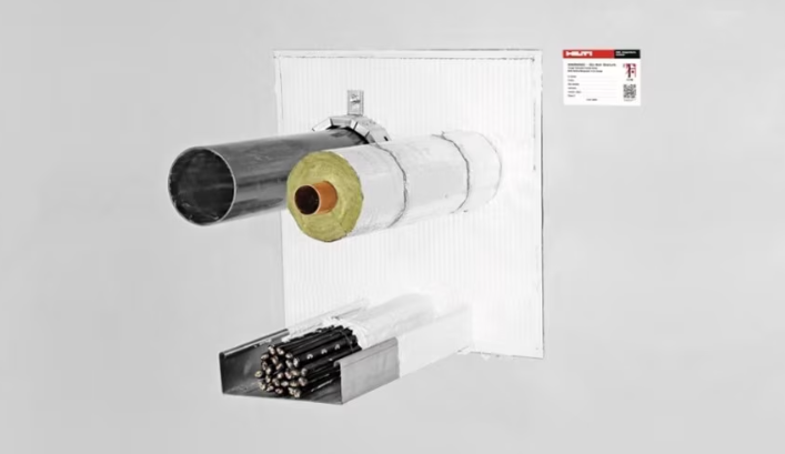 Firestop installation with insulated pipe and cable tray passing through a sealed wall opening, showing a white-coated system with a �������� identification label.