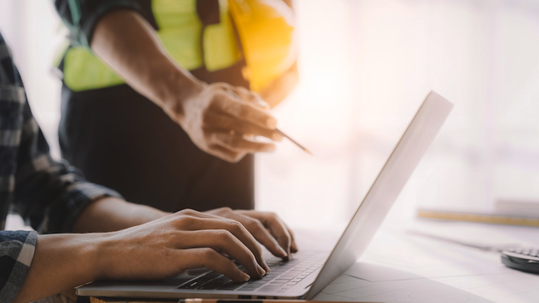 Construction workers on laptop