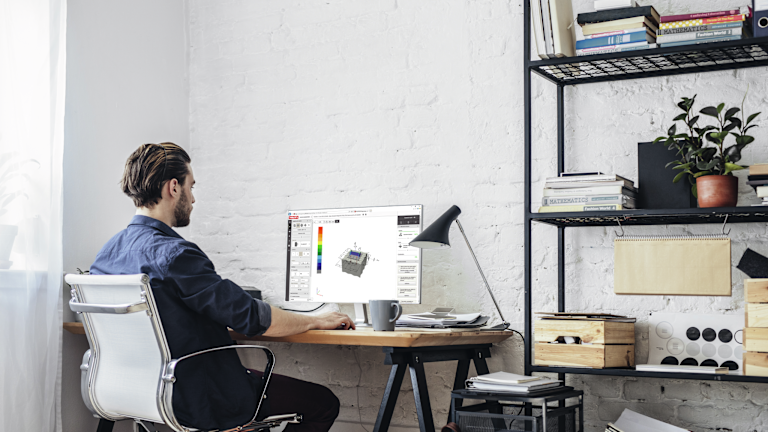 Man at computer desk looking at PROFIS software on his screen