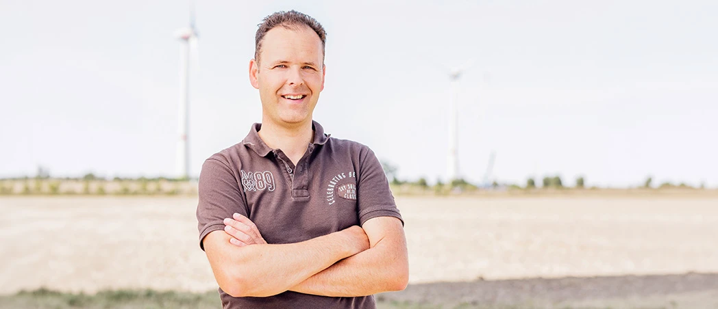 DKB-Kunde vor Windkraftanlage