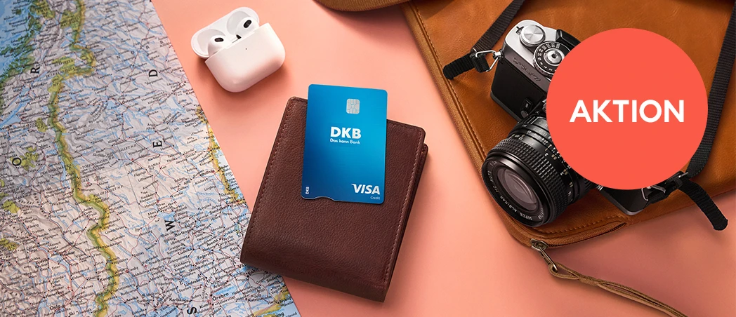 DKB Visa Kreditkarte auf Geldbörse, umgeben von Reiseutensilien