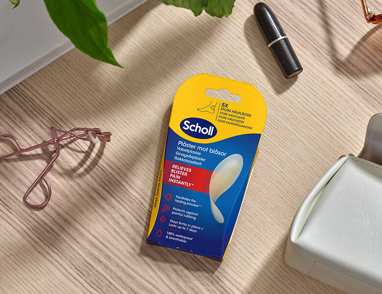 Her ses der et gulv, hvorpå der ligger en pakke med Scholl vabelplaster.