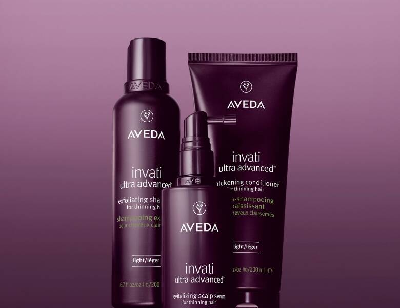 Tre Avedaprodukter på en mørk baggrund