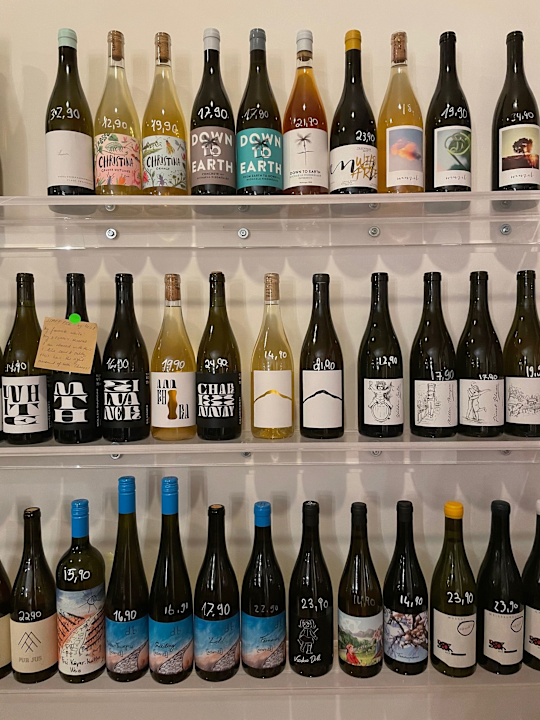 a shelf full of diverse winebottles