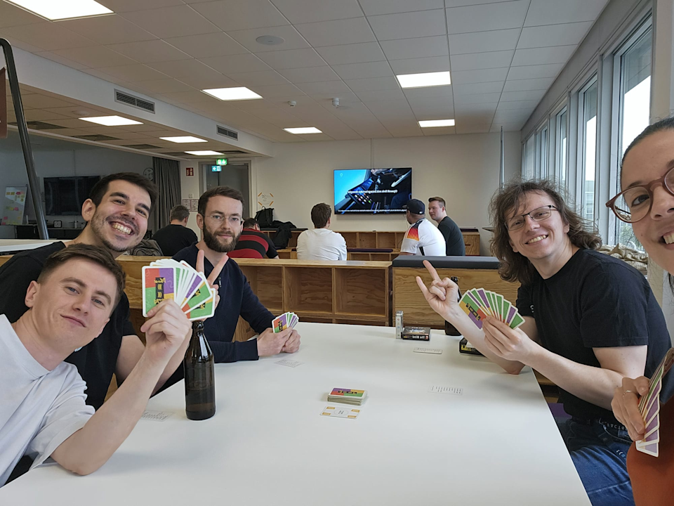 a group of people playing cards