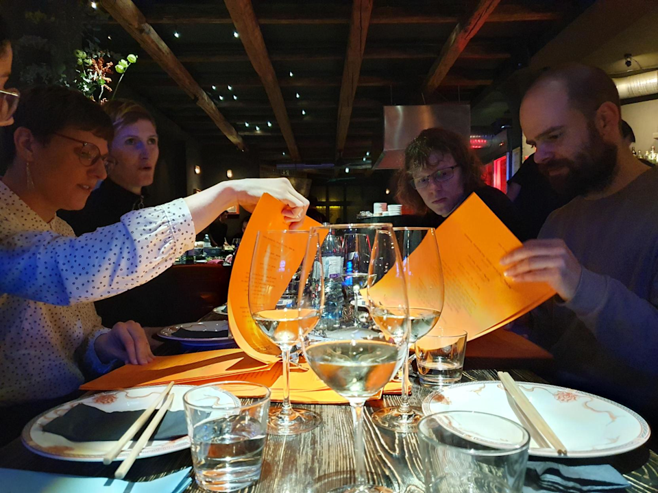 a group of people checking menus in a restaurant
