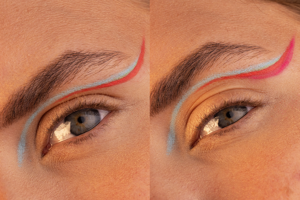 Lähikuva kahdesta silmästä, joissa taiteellinen sininen ja punainen eyeliner kulkee luomen yli kohti kulmakarvaa