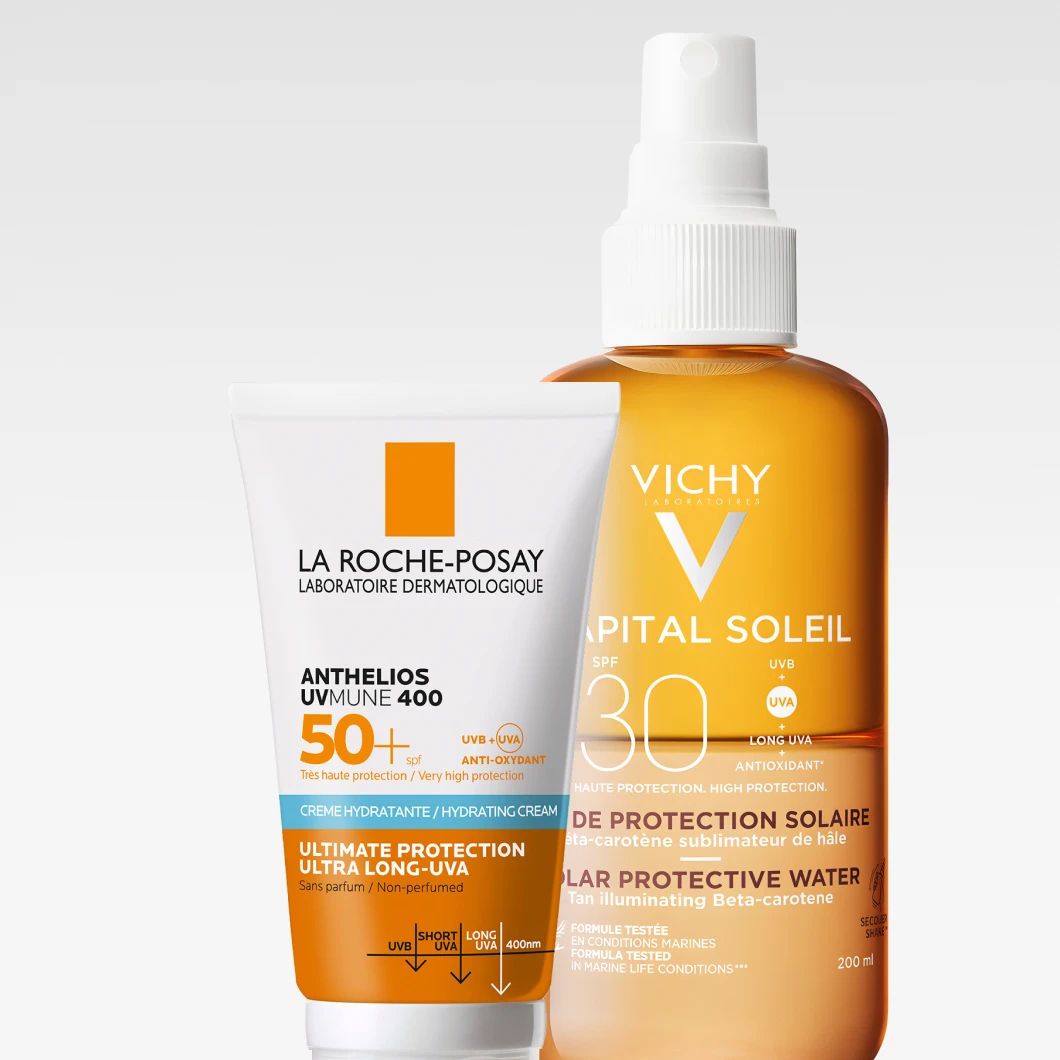 La Roche-Posay Anthelios UVmune 400 SPF 50+ och Vichy Capital Soleil SPF 30 står sida vid sida mot en ljus bakgrund, med fokus på högskyddande solkräm och solspray.