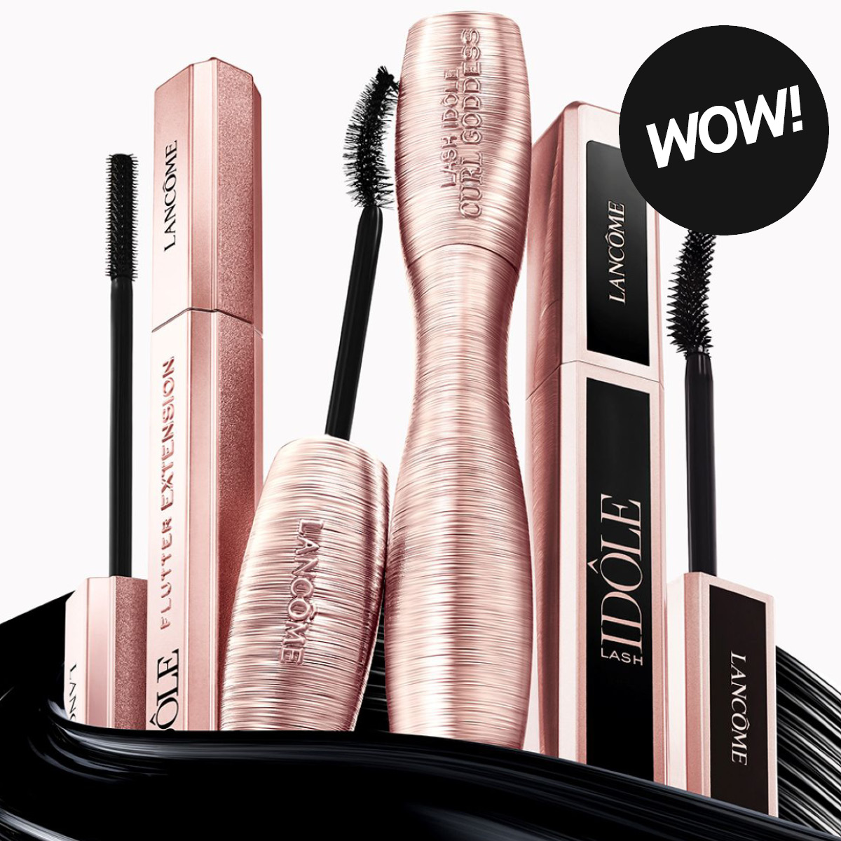Lancôme Lash Idôle mascara med roséguldfärgade förpackningar och svarta mascaraborstar mot ljus bakgrund samt texten “WOW!”. Produkterna visar Lash Idôle Flutter Extension och Lash Idôle mascara för volym och separerade fransar.