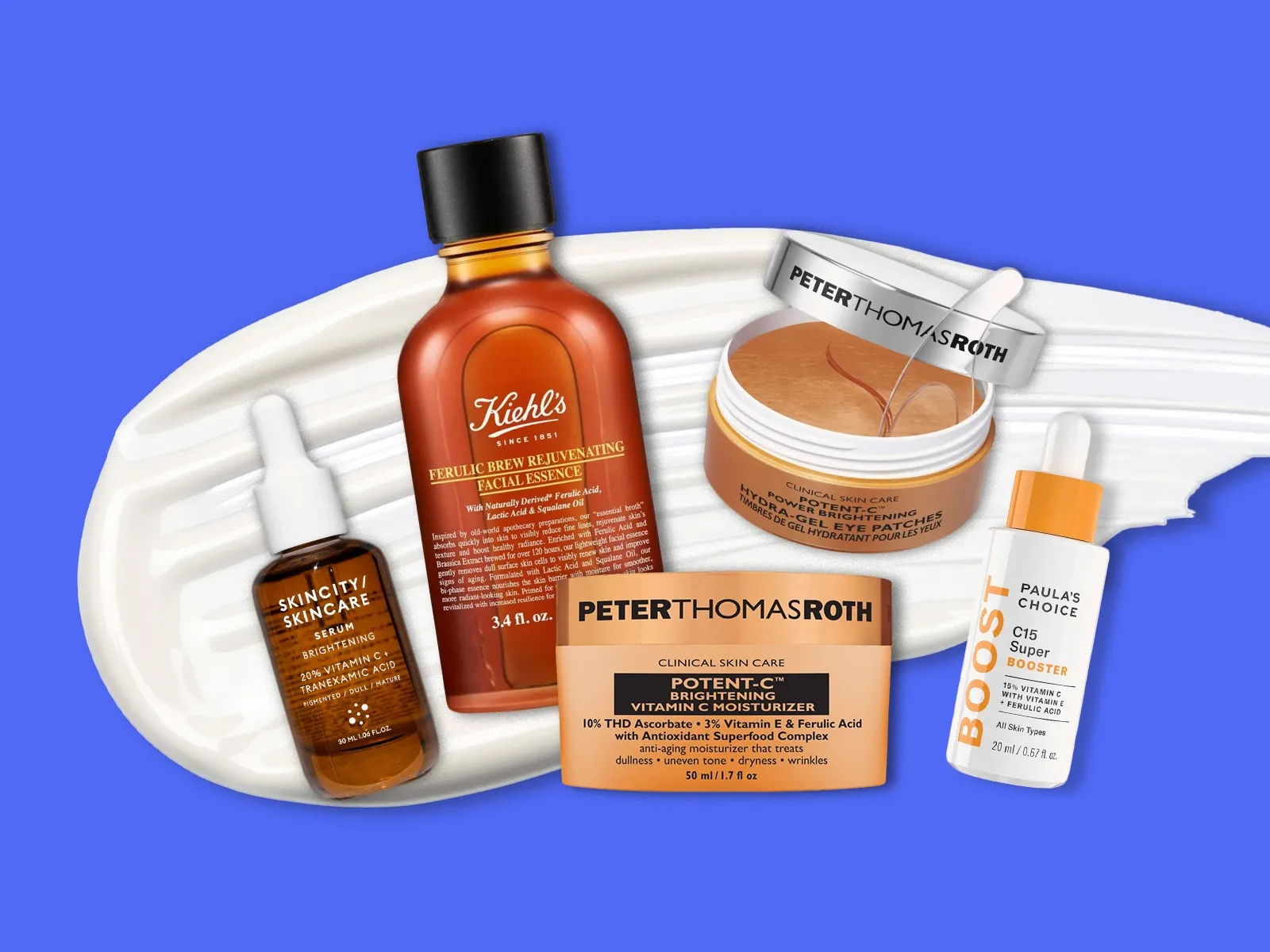 Flere hudpleieprodukter plassert på en hvit krem mot en blå bakgrunn.
