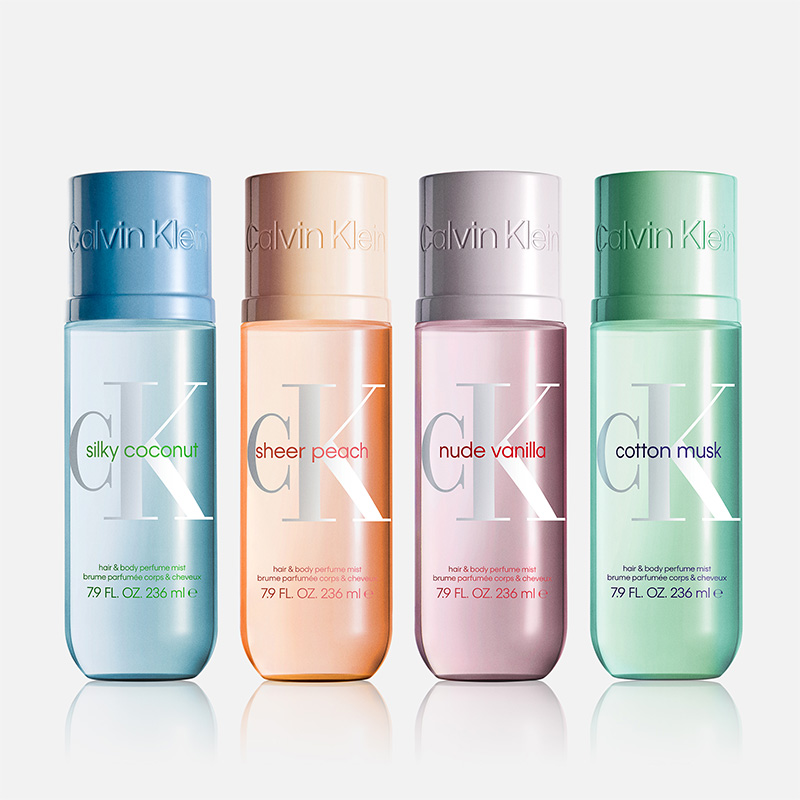 Fyra färgade flaskor av Calvin Klein CK hair & body perfume mist med dofterna "silky coconut", "sheer peach", "nude vanilla" och "cotton musk". På flaskorna står även "Calvin Klein", "hair & body perfume mist", "7.9 FL. OZ 236 ml" och "brume parfumée corps & cheveux".