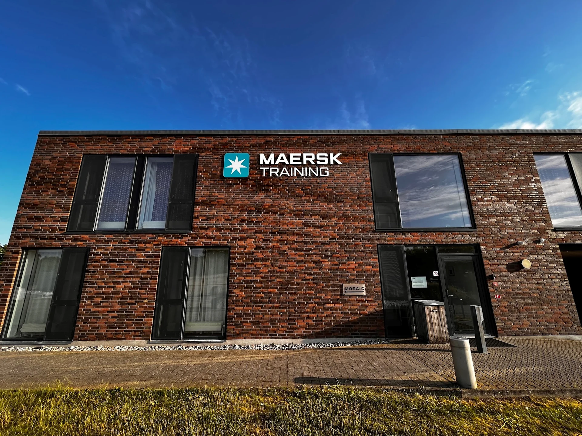 Maersk Training in Svendborg hotel on sunny day with Maersk Training logo