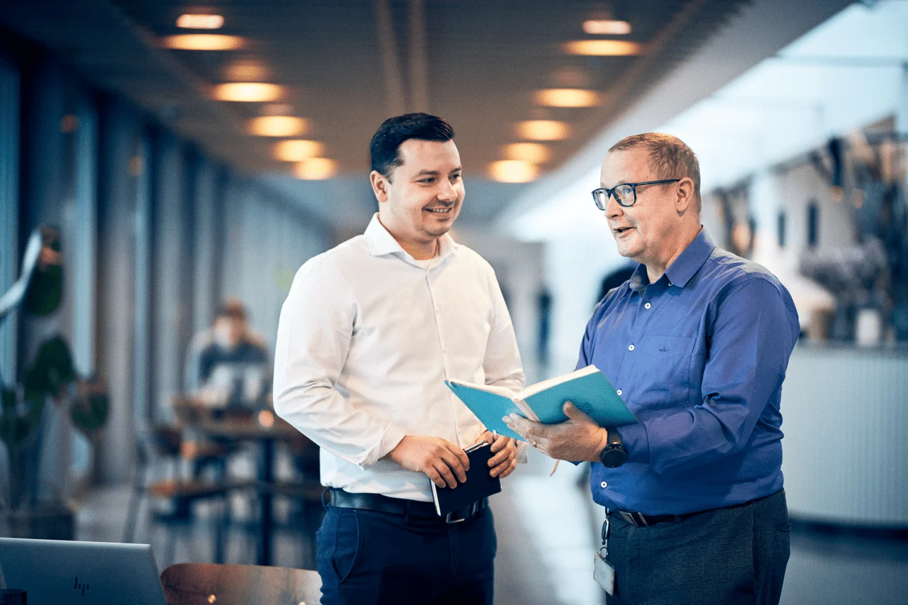 colleagues-brief-in-office-min