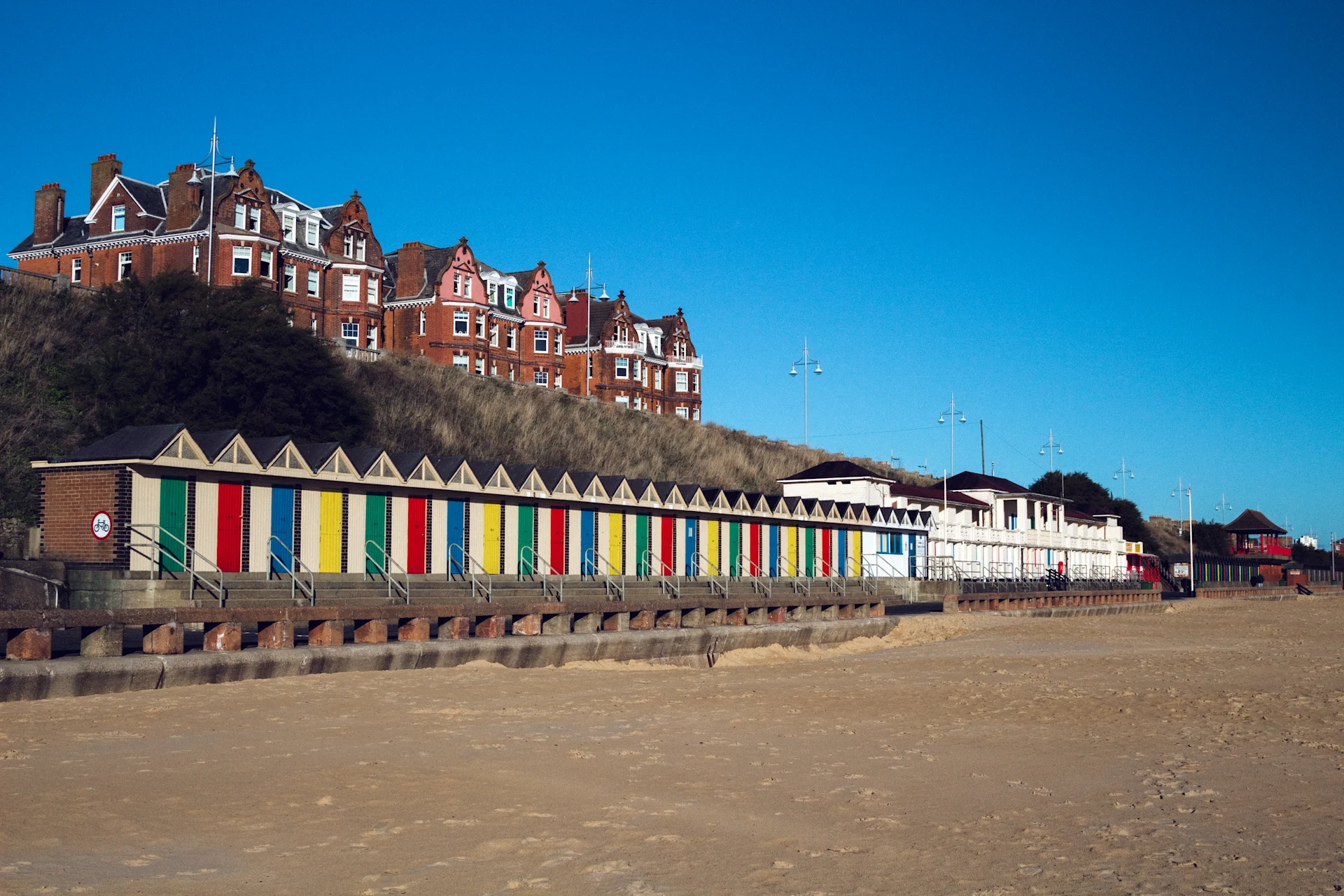 Colourful beach huts line the seafront at Lowestoft, adding charm to this classic English coastal destination known for its sandy beaches and scenic promenade.