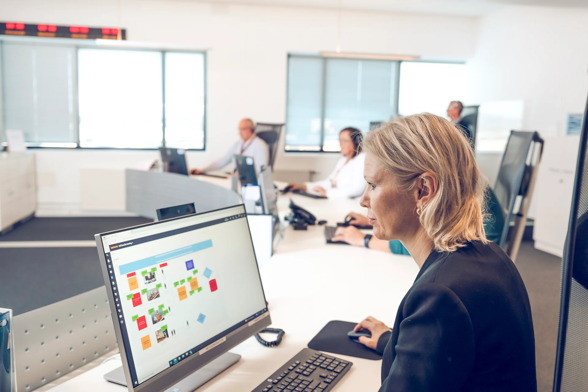 Crisis management team coordinating response efforts in a dedicated control room, ensuring quick and effective decision-making during emergencies.