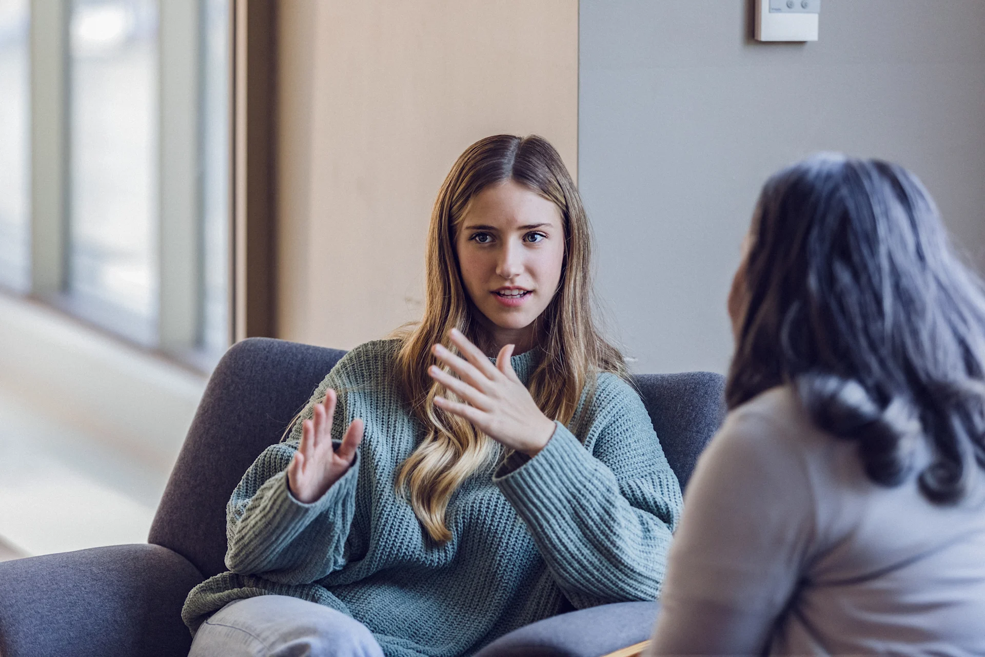 Young adult talking with peer
