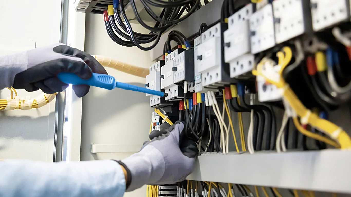 Engineer inspecting electrical box ensuring everything is up and running.