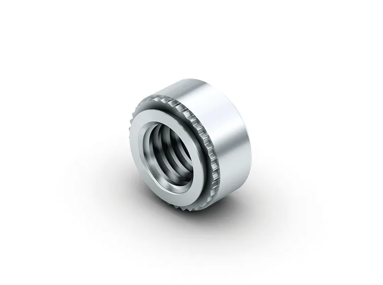 A self-clinching nut on a white background.