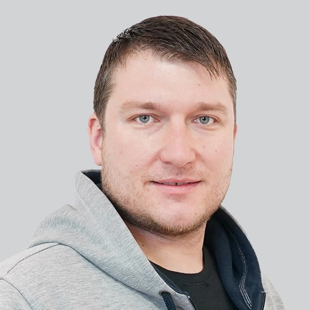 Portrait of a man with brown hair and blue-green eyes