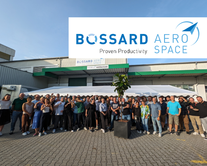 Bossard Aerospace Team picture in front of the warehouse with logo banner