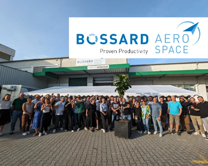 Bossard Aerospace Team Bild vor dem Lager mit Logo-Banner