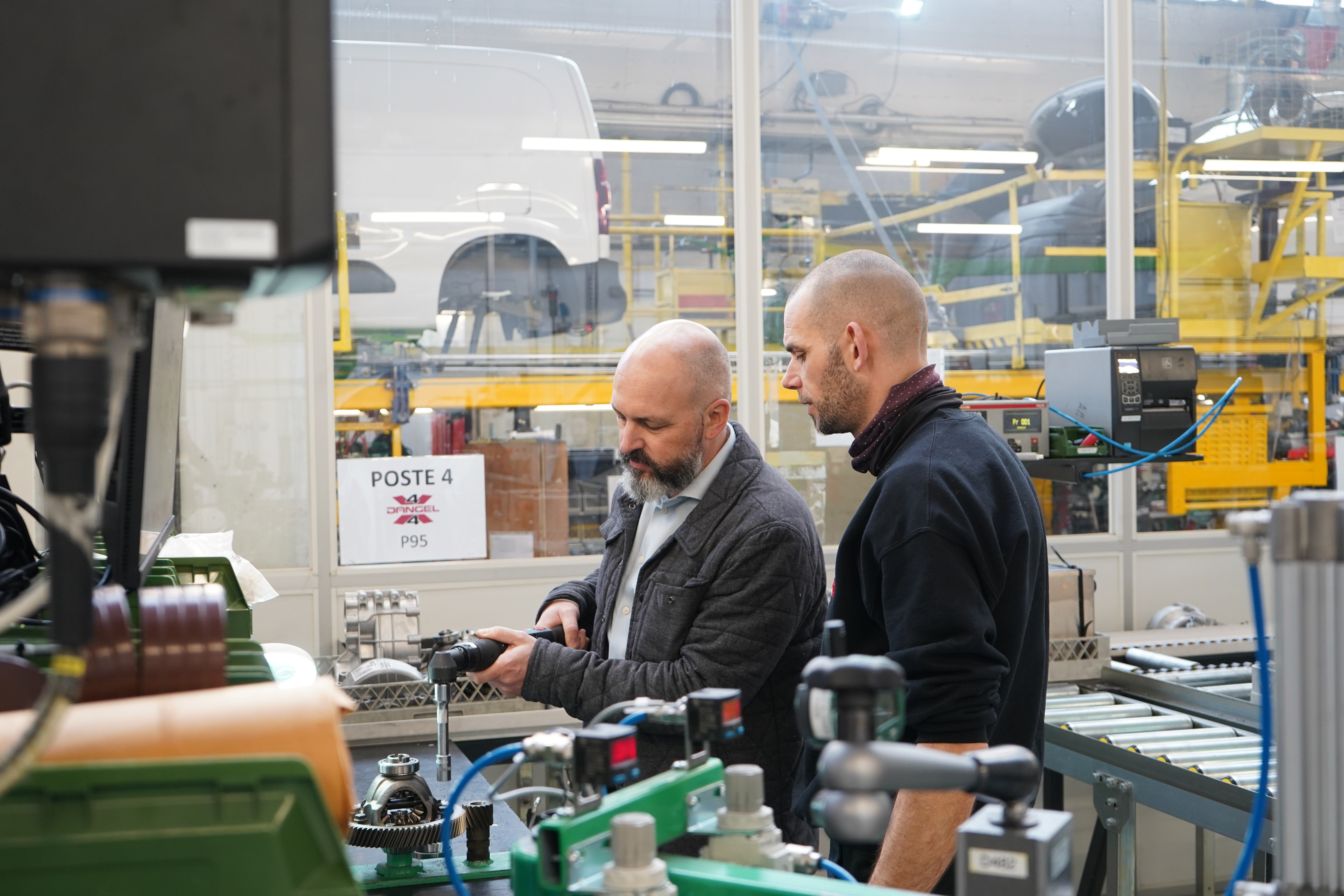 Two men at a Smart Factory Assembly Station at Dangel