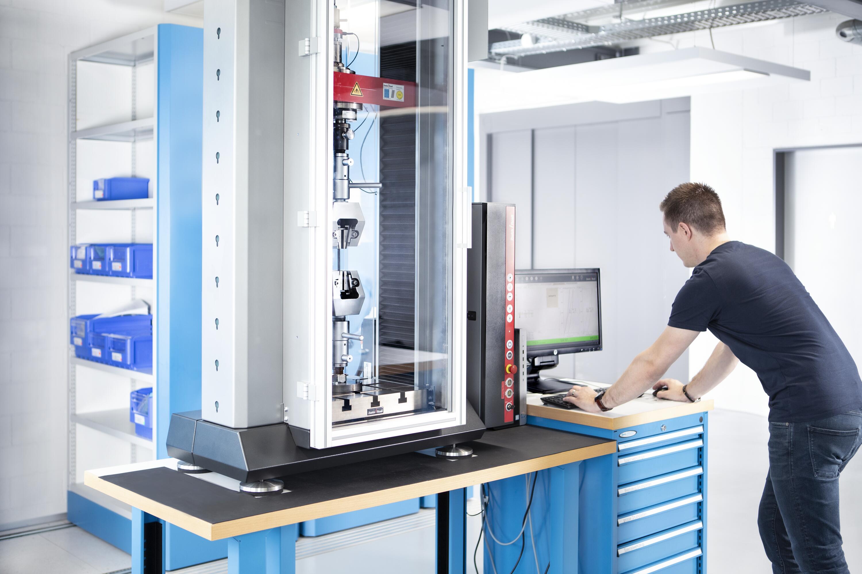 Engineer is conducting a tensile strength test in a technical test lab.