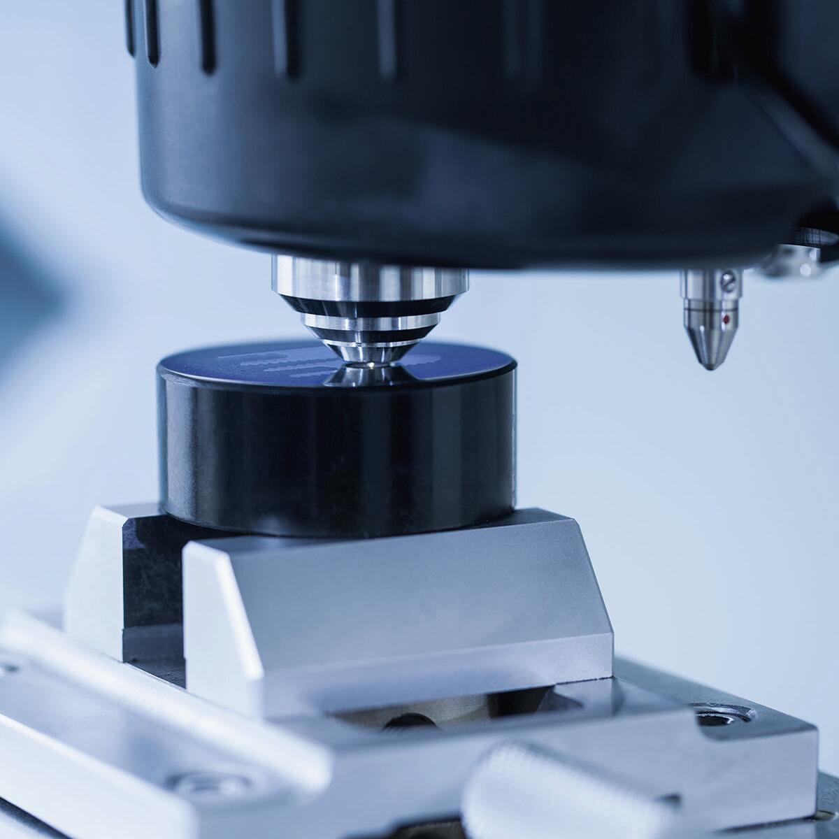 Close-up of hardness testing machine.