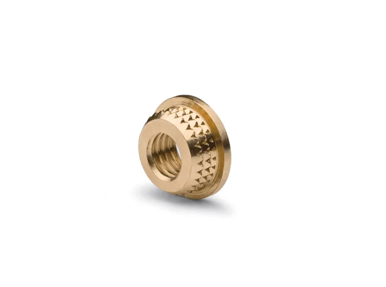 A brass threaded inserts on a white background.