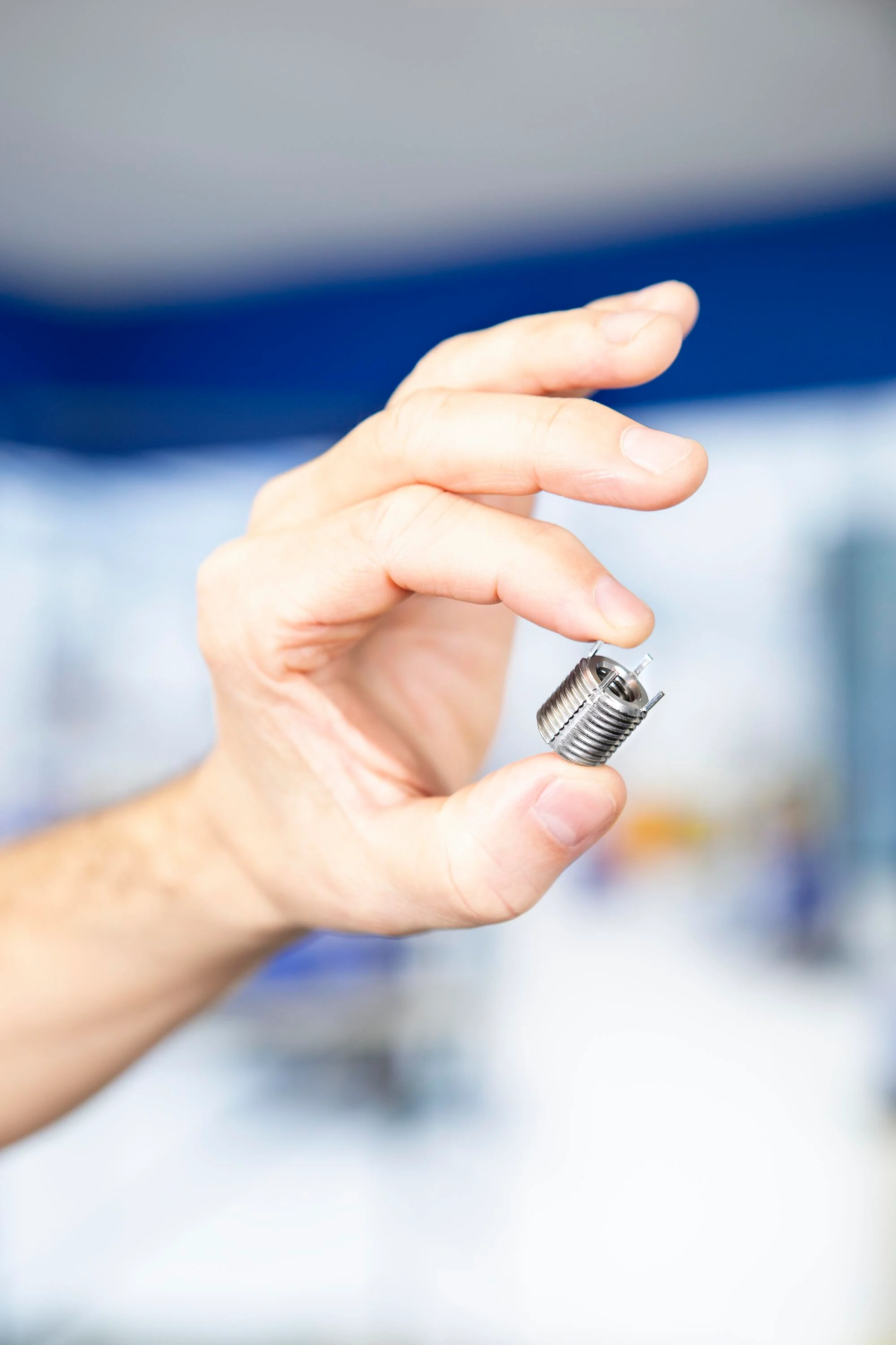 Hand holding a Keenserts threaded insert