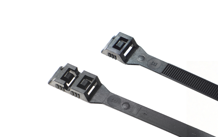Two black Elematic Easy Belturing cable ties on white background