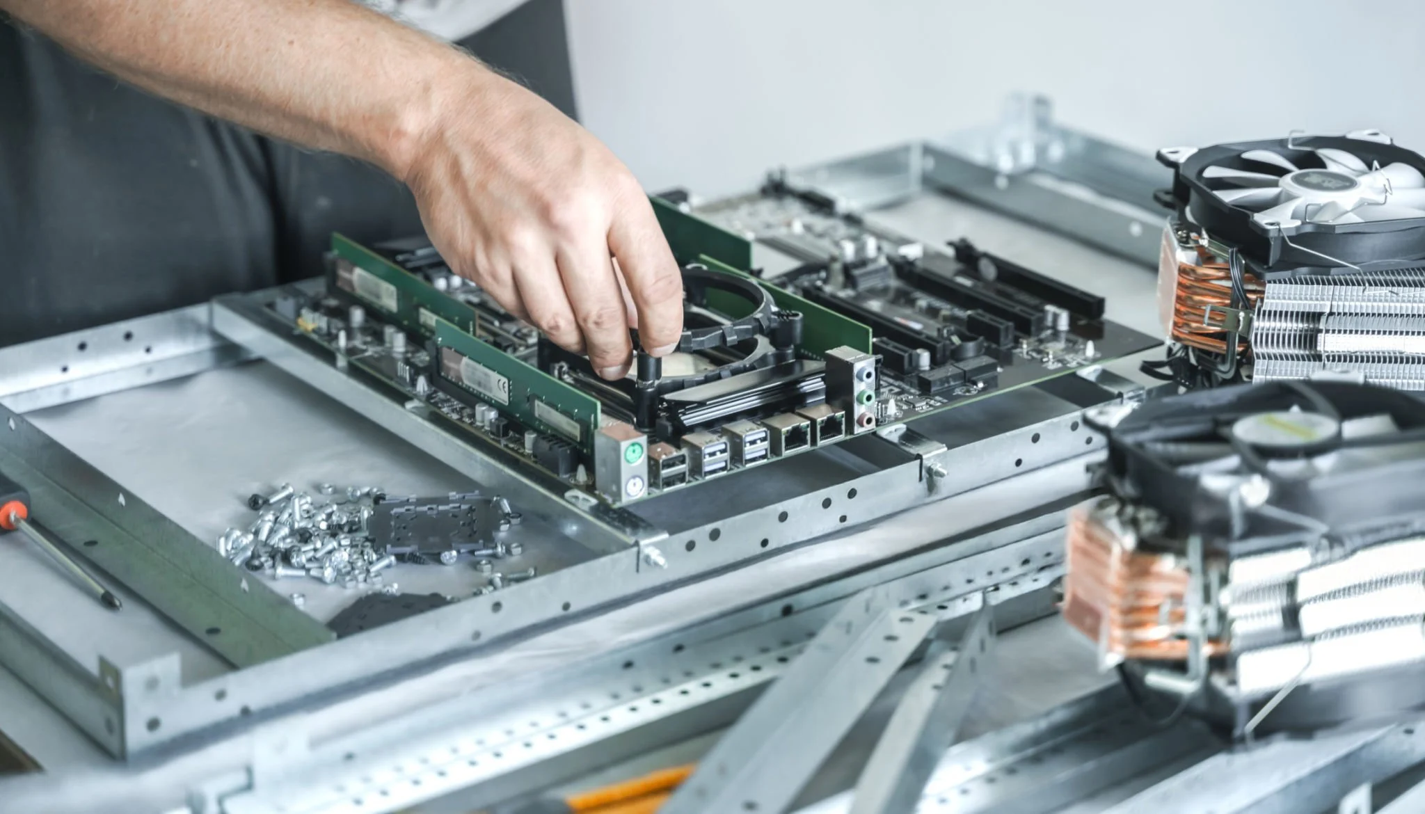 A man working on a typical motherboard 