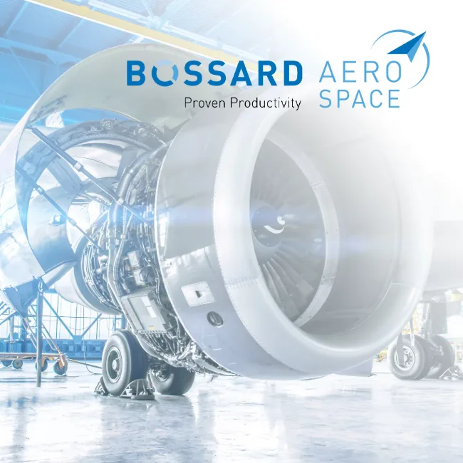 A close-up of an airplane engine situated in a hangar with blue walls, highlighting its mechanical features.